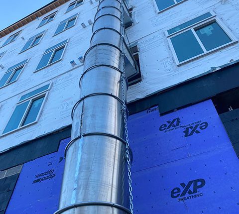 aluminum chute attached to housing complex